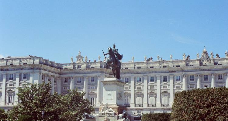 Equestrian statue in front of a royal palace.