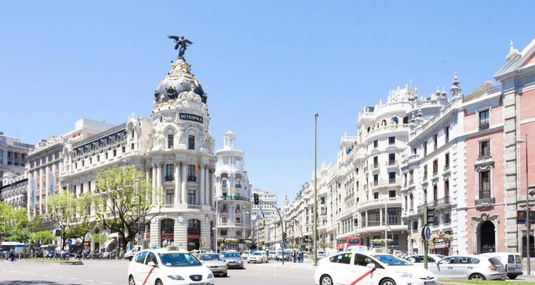 Bustling city intersection with historic architecture.