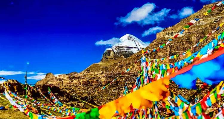 Mountain with colorful prayer flags in the foreground.
