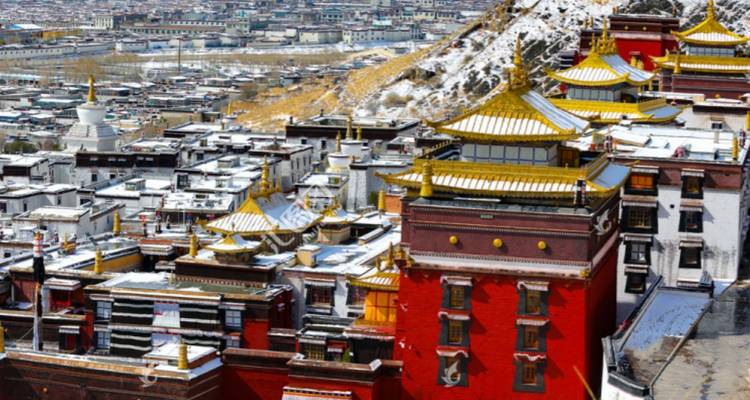 View of a city with colorful temple rooftops.