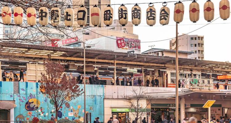 Japanese train station with hanging lantern decorations.