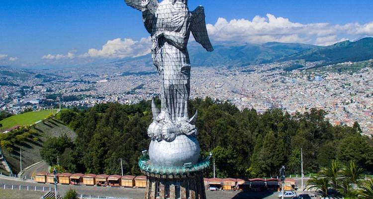 Statue of the Virgin of Quito with cityscape in the background.