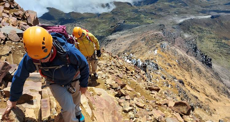 Two climbers ascending a rocky mountain path.