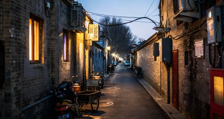 Narrow alley in a traditional neighborhood at dusk.