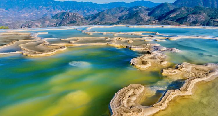 Hierve el Agua's natural rock formations and pools in a mountainous area.