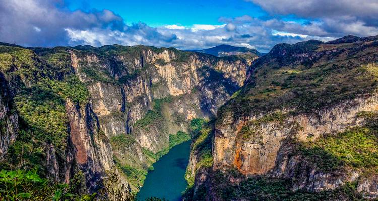 Sumidero Canyon with steep cliffs and a winding river.