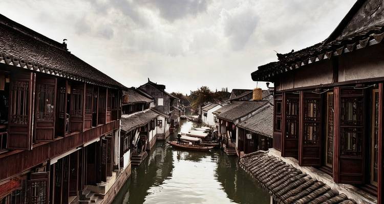 Traditional Chinese canal town with classic buildings lined along the water.