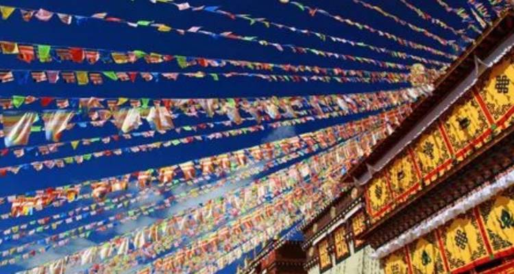 Colorful prayer flags and bright blue sky.