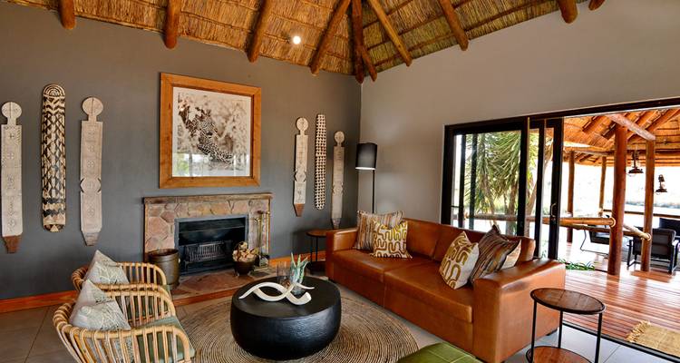 Interior of a lodge with a rustic living room and fireplace.