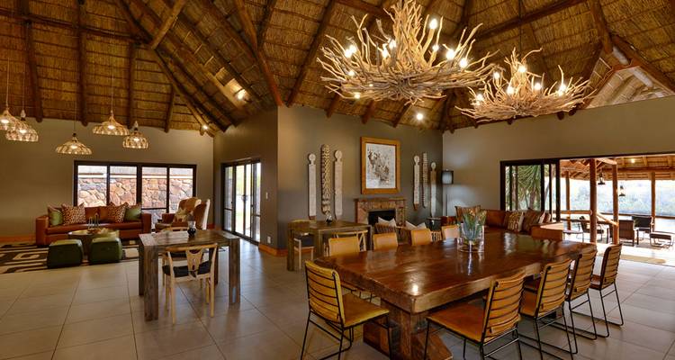 Large dining area in a lodge with a rustic table and decor.