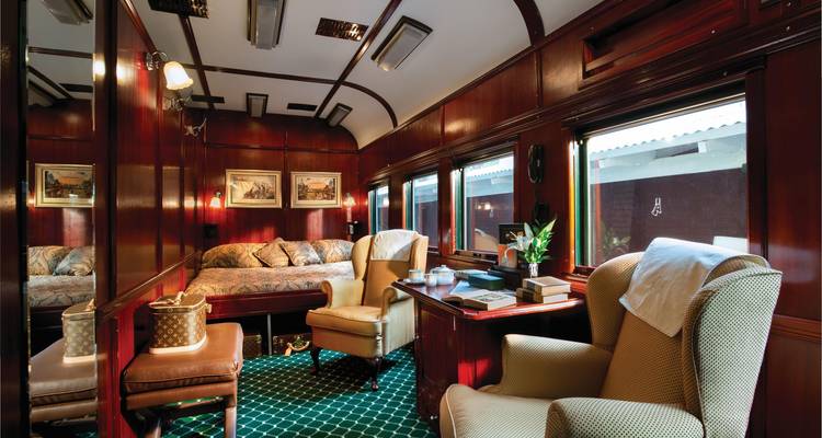 Luxurious train lounge with elegant seating and decor.