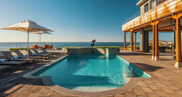 A swimming pool on a terrace with views of the ocean.