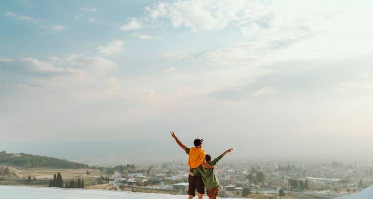 Two people enjoying a scenic view overlooking a town.