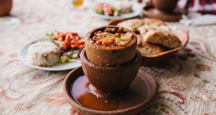 Traditional Turkish pottery dish with stewed food.