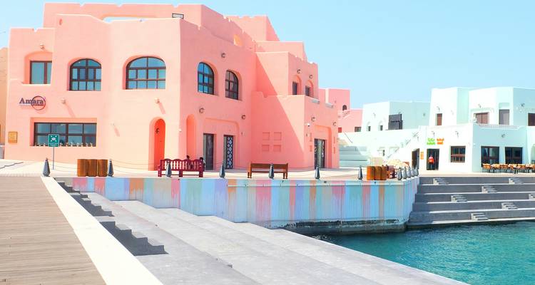 Colorful buildings by the water in a vibrant setting.