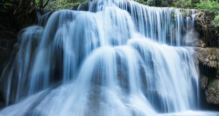 Silky cascades of a multi-tiered jungle waterfall in northern Thailand.