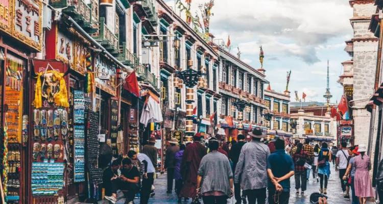 Busy street with traditional buildings and people walking.