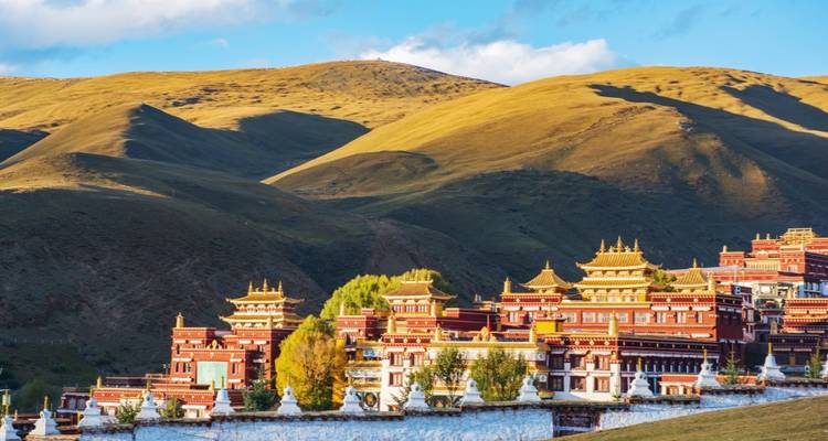 Buddhist monastery with rolling hills in the background.