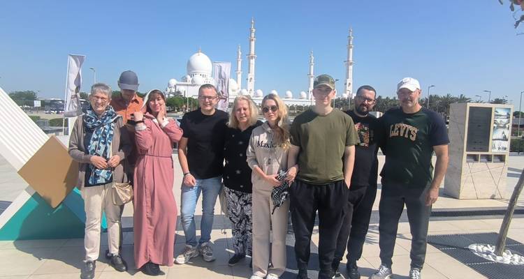 Groupe devant une mosquée aux dômes blancs.