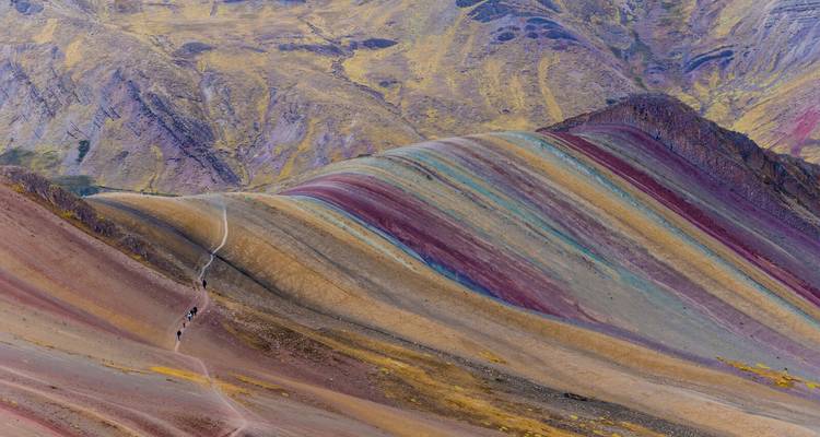 Rainbow Mountains with a path and tourists hiking.