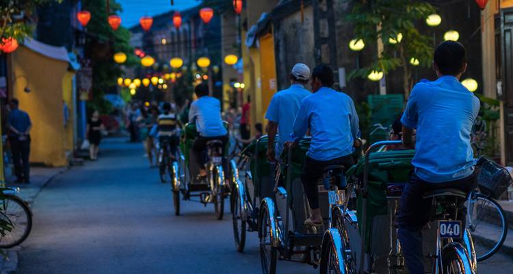 People riding bicycles with lanterns overhead