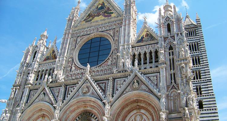 Siena Cathedral with ornate marble facade and a tall bell tower.