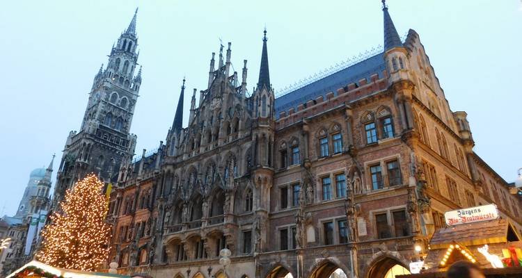 Historical building with tall spires and Christmas decorations.