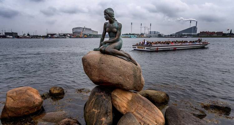 Little Mermaid statue on a rock in the harbor.