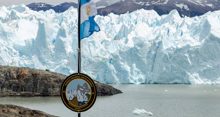 Close view of Perito Moreno Glacier with an Argentinian flag.