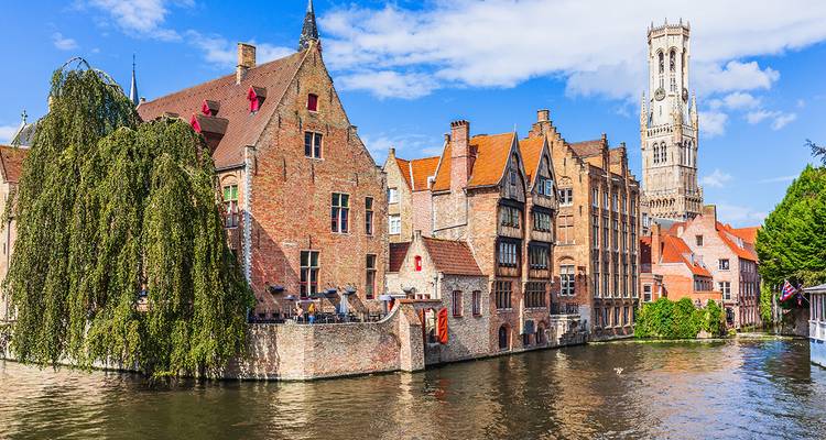 Bruges canal with historic buildings by the water.