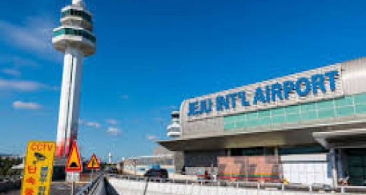 A view of Jeju International Airport with a control tower.