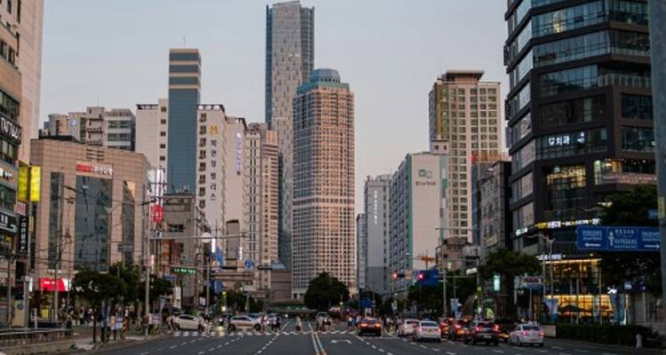 Street scene in a city with tall buildings and cars.