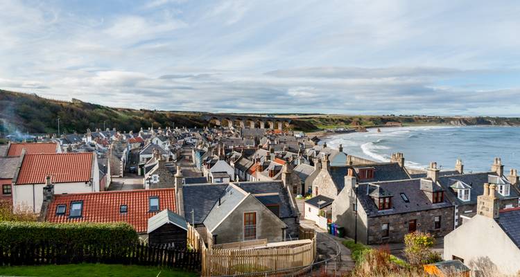 Coastal town with rooftops near the beach.
