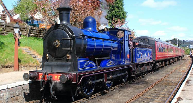 Vintage steam train on a railway track.