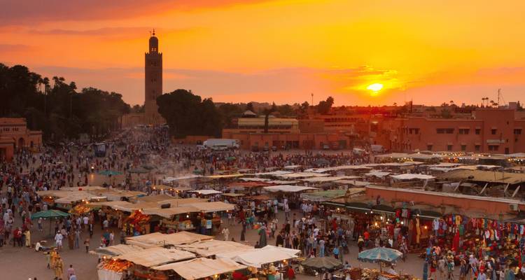 Vibrant sunset over Marrakech's bustling market square.