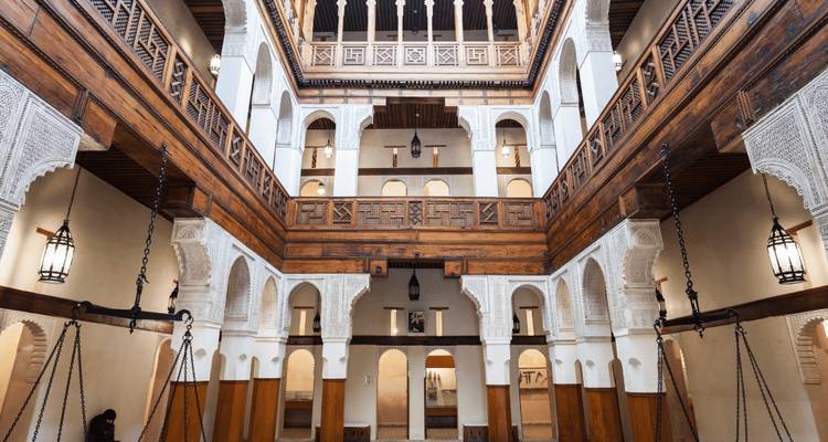 Elegant interior of a historic building with arches and wood.