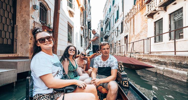 People in a gondola in a Venetian canal.
