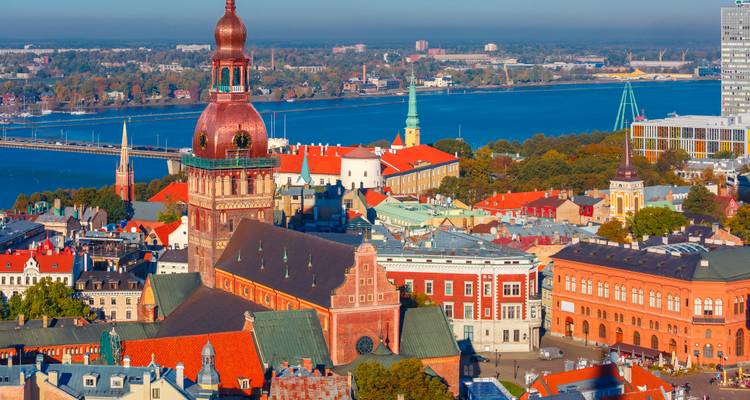 Aerial view of Riga's old town with red rooftops and a prominent cathedral.