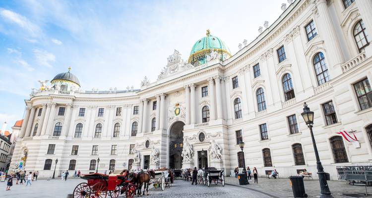 Hofburg Palace in Vienna with horse-drawn carriages.