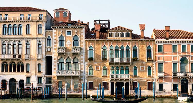 Colorful Venetian buildings with canal and gondolas.