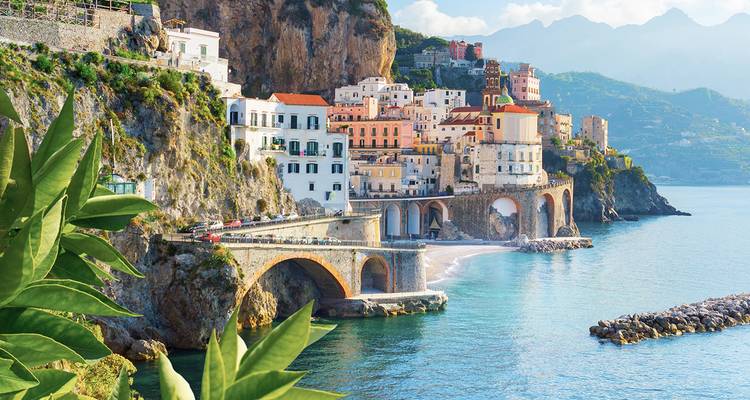 Colorful coastal town on steep cliffs by the sea.