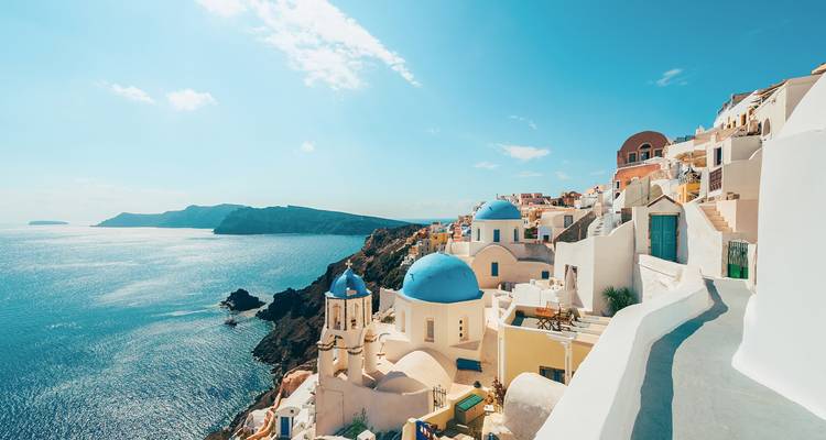 Iconic white buildings with blue domes in a coastal village.
