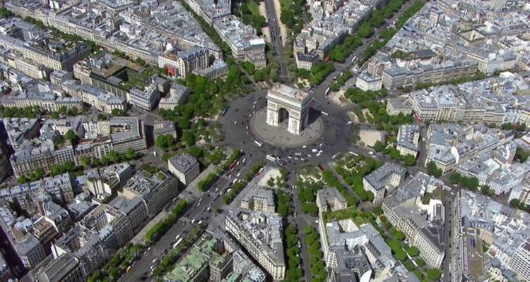 Aerial view of the Arc de Triomphe and surrounding avenues in Paris.