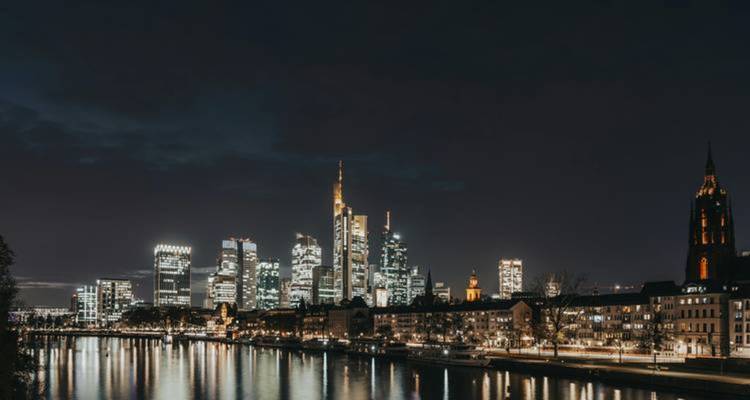 Frankfurt skyline at night reflected in the river.