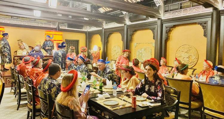 Group of people dining in traditional costumes.