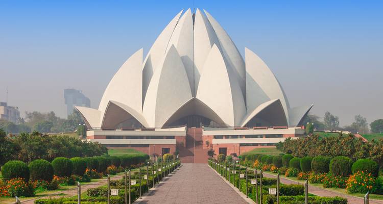 Lotus Temple in Delhi, surrounded by lush gardens.
