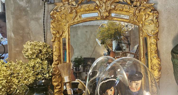 Miroir orné avec reflet d'intérieur de boutique.