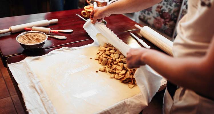 Chef preparing a strudel on a table