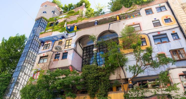 Colorful, whimsical building with plants on the facade