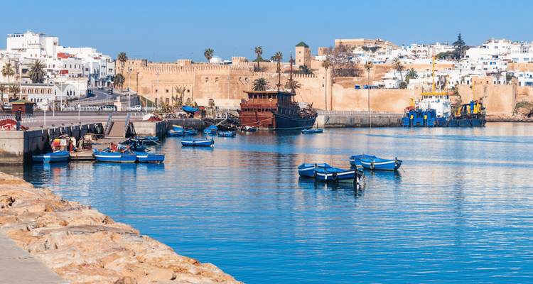 A coastal fort with boats docked nearby.